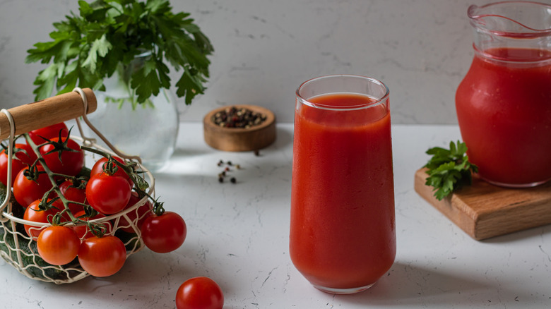 Glass of tomato juice with fresh tomatoes