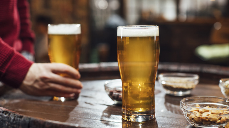 Beer on wooden pub bar nuts 