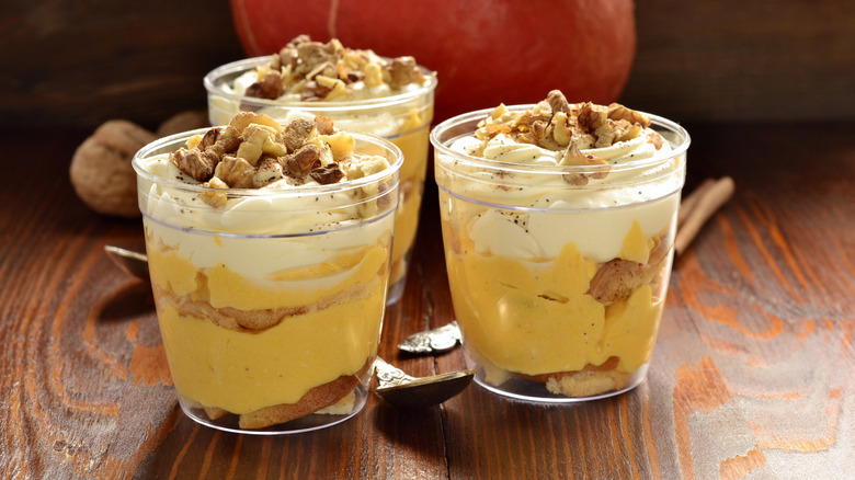 Trifle in jars on table