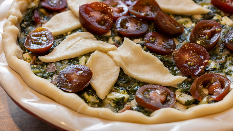 Rope crust pie with petal cutouts and tomatoes