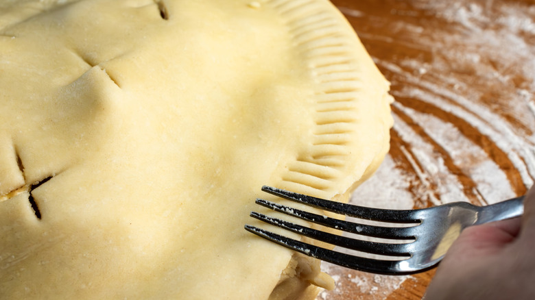 Crimping a pie crust with a fork