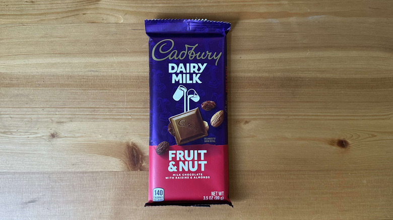 Cadbury Dairy Milk candy bar on wooden table