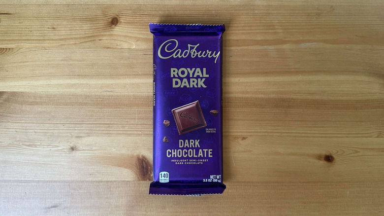 Cadbury Royal Dark candy bar on wooden table