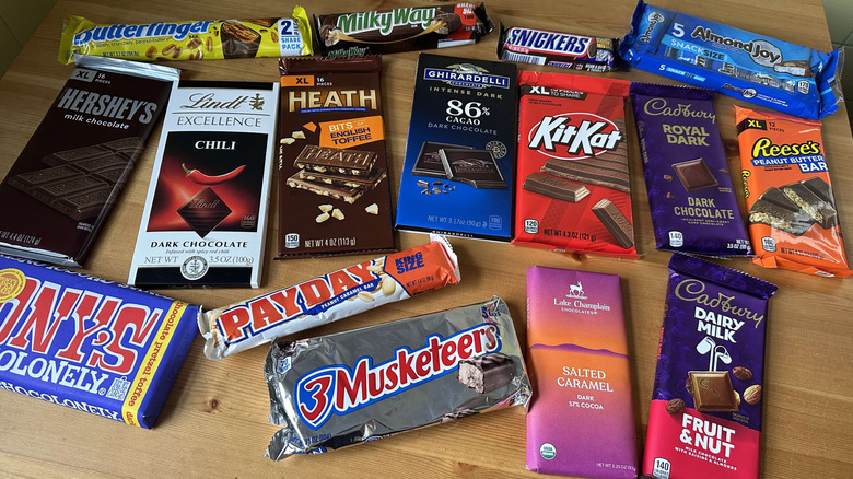 Variety of candy bars on wooden table