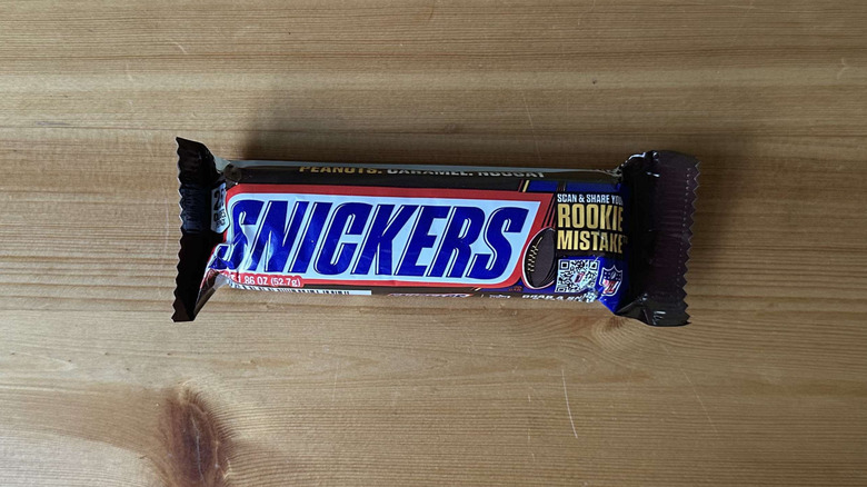 Snickers candy bar on wooden table