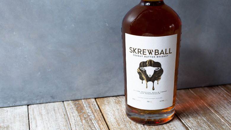 Skrewball Peanut Butter Whiskey bottle on table