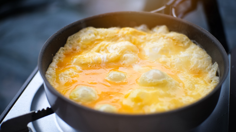 Omelet cooking in a skillet