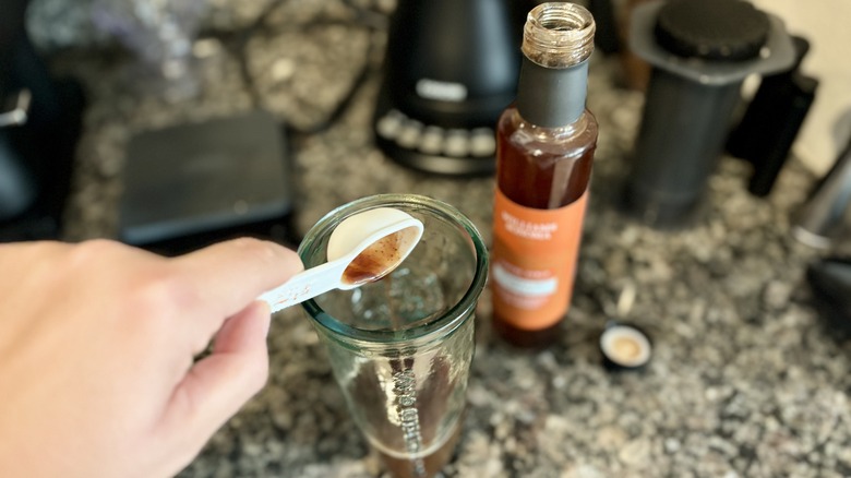 Pouring syrup in coffee