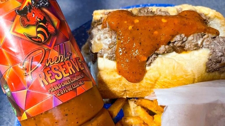 Cheesesteak sandwich dripping hot sauce