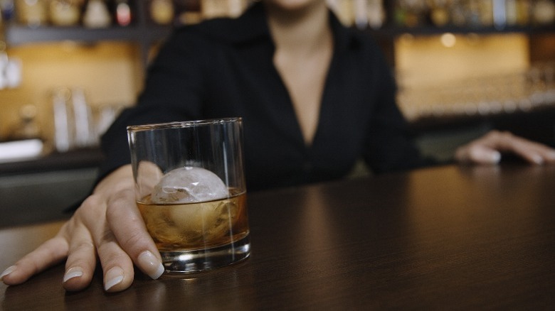 A bartender serving whiskey 