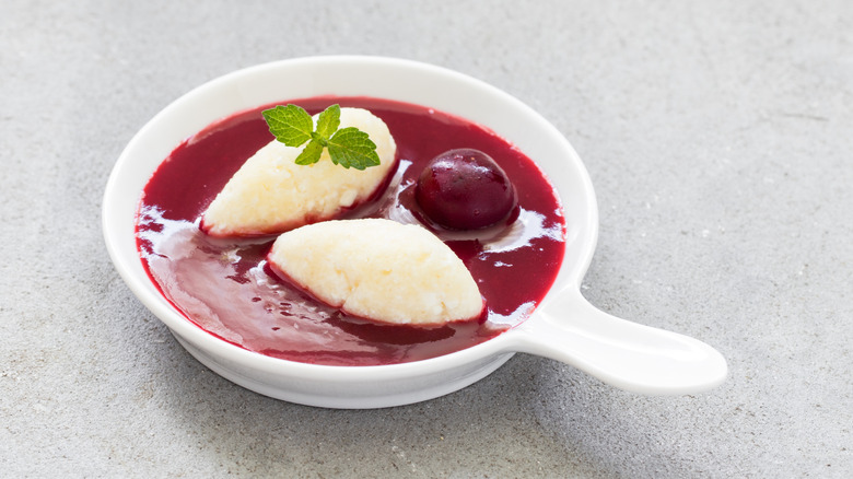 Cottage cheese quenelles with cherry sauce. Close-up