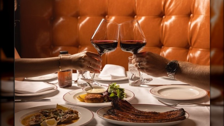 A couple enjoying a meal at Rocco Steakhouse