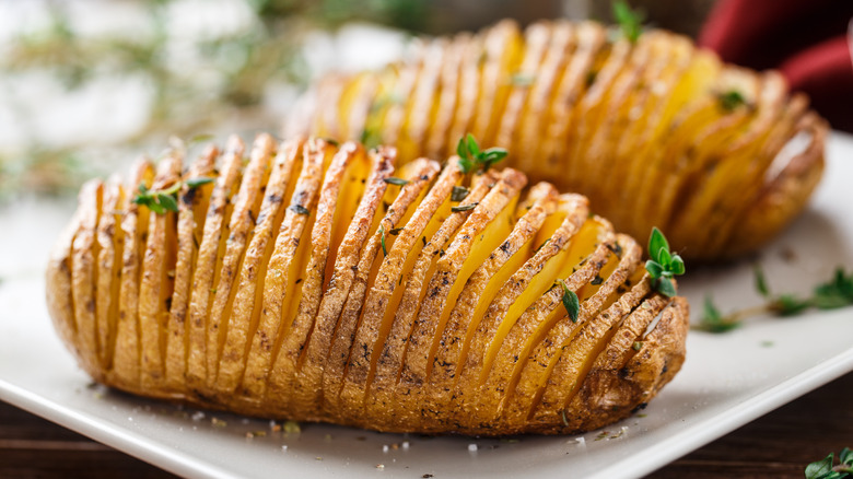 Sliced baked potatoes on white plate 