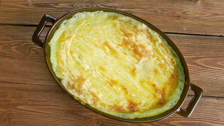 Potato casserole in black pan 