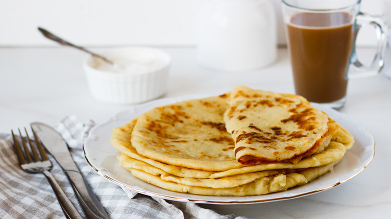 Thin pancakes on white plate 