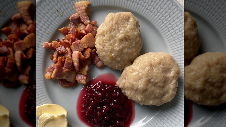 Potato dumplings and bacon on blue plate