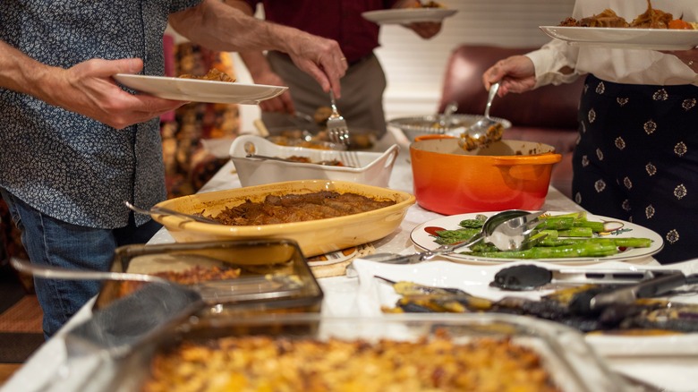 Holiday potluck with people scooping