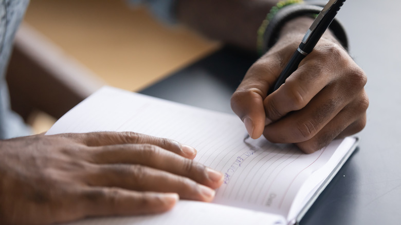 Person writing on paper