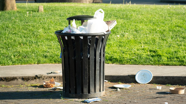 Overflowing outside trash can