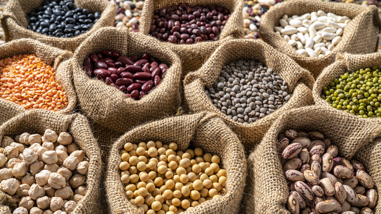 Various types of beans in burlap bags