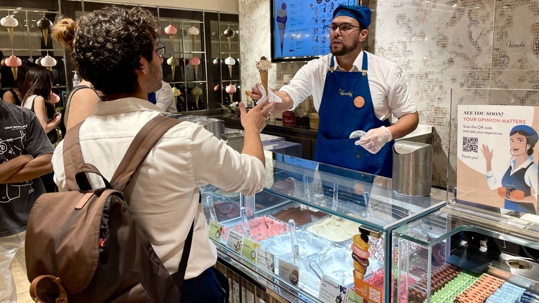 Worker serving gelato at Venchi