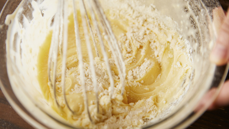 Making cake with whisk and bowl