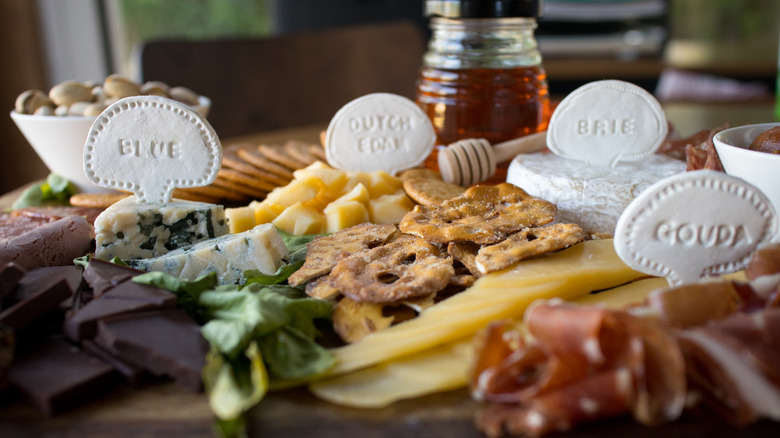 charcuterie board with labeled cheeses