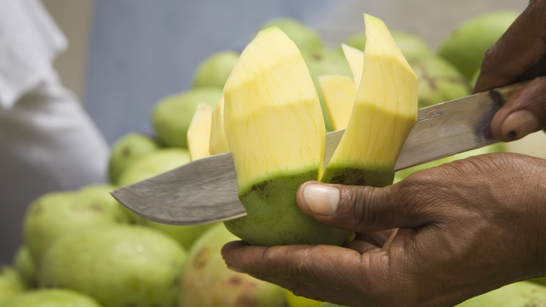 green mango being sliced