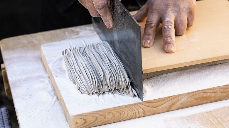 Knife slicing soba noodles