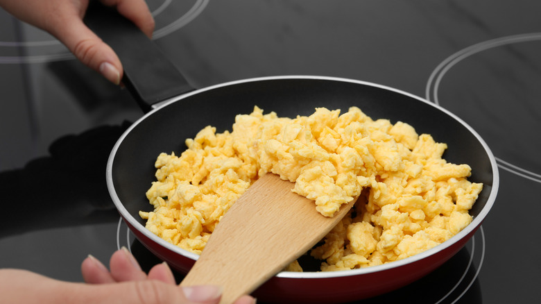 Stirring scrambled eggs in pan