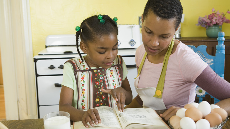 People reading recipe in kitchen