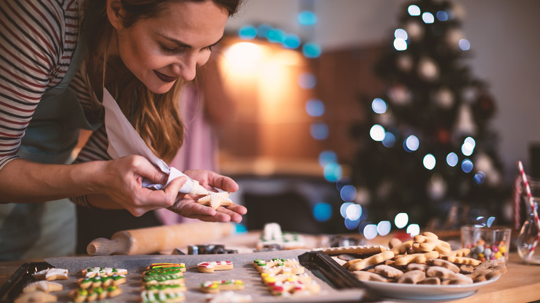 Person decorating holiday cookies