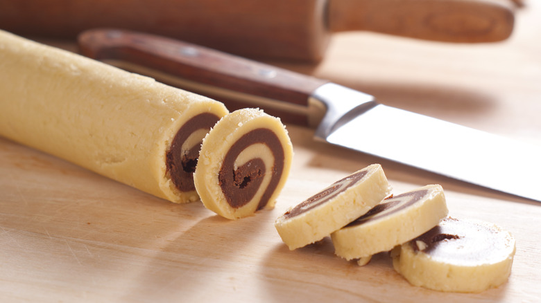 Log of cookie dough on surface