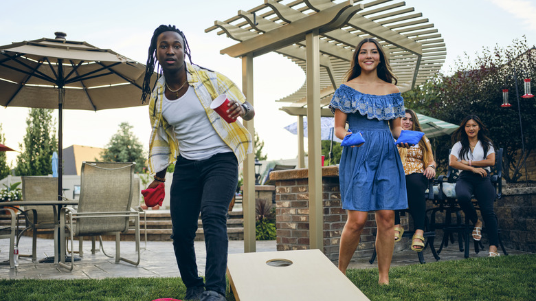 People playing cornhole outside