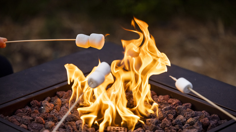 Making s'mores over fire pit