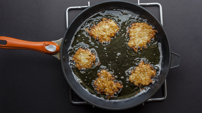 Cooking potato pancakes in skillet