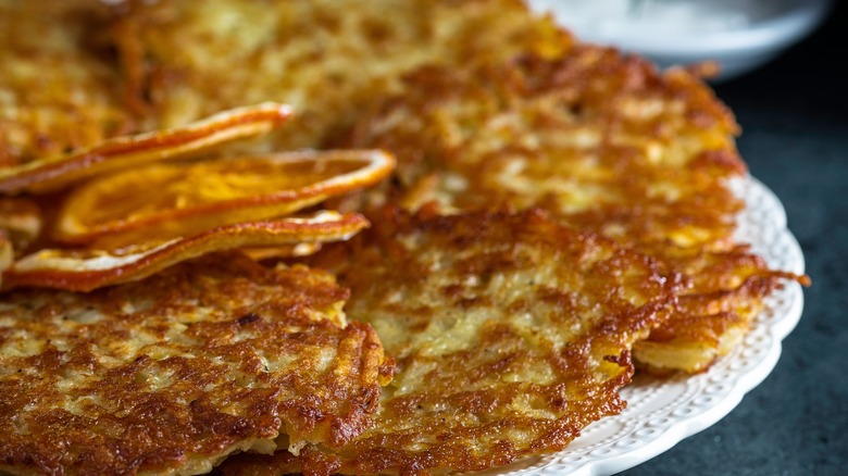 Latkes on plate with orange