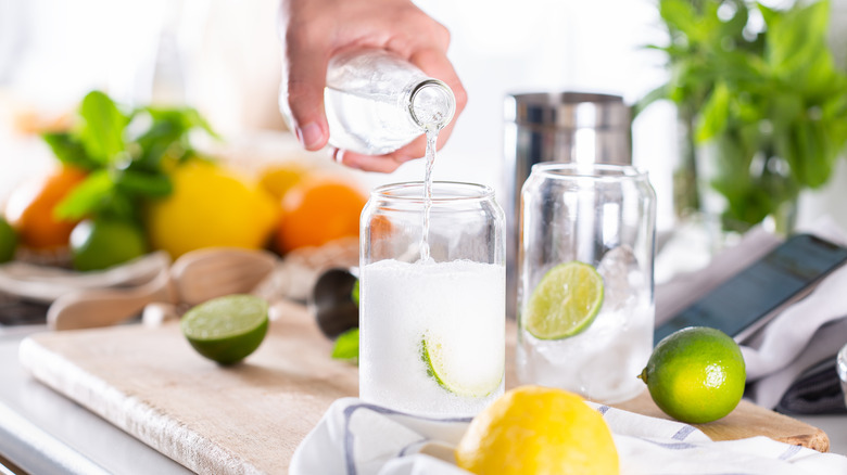 Pouring seltzer into glass