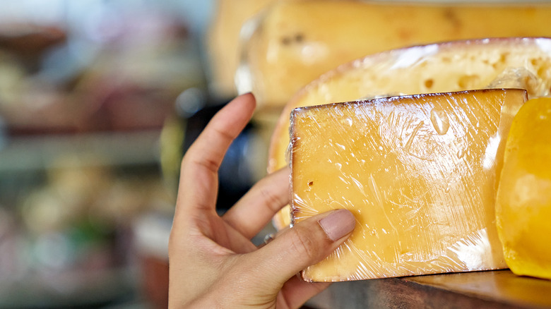 feeling cheese at grocery store