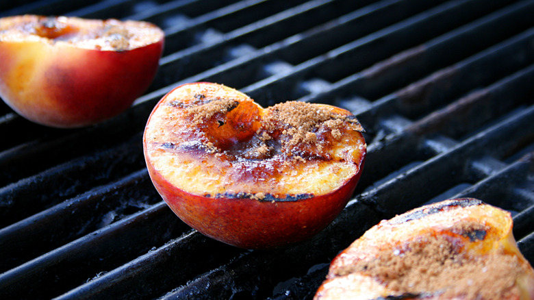 Peaches on a grill with brown sugar on top