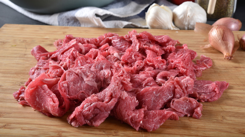 Shaved beef on a cutting board