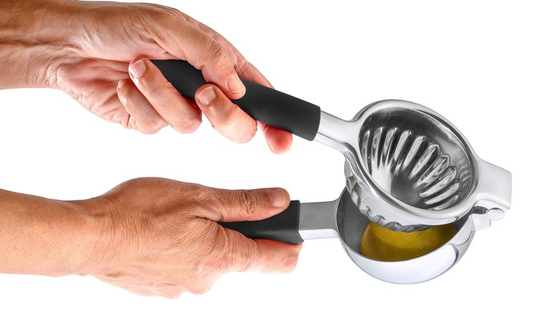 hands clutching lemon squeezer