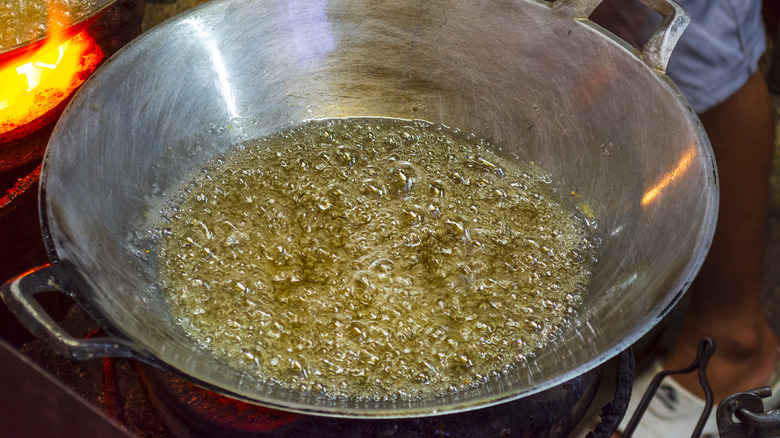 A wok filled with boiling oil