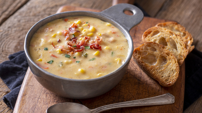 bowl of homemade corn chowder with toast on side