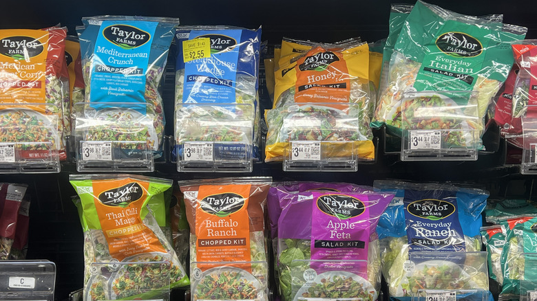 Bags of packaged salads at the produce aisle in store