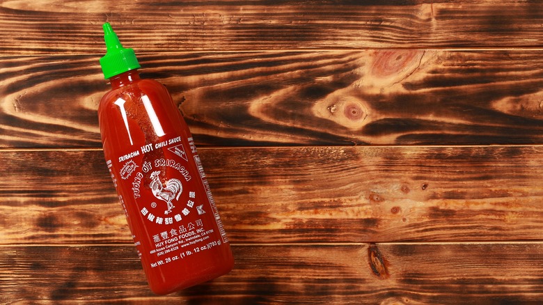 Sriracha bottle on table