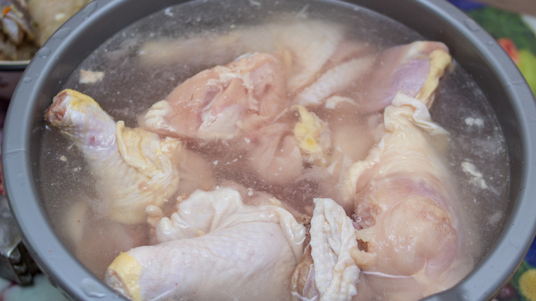 Raw chicken in a bowl of water