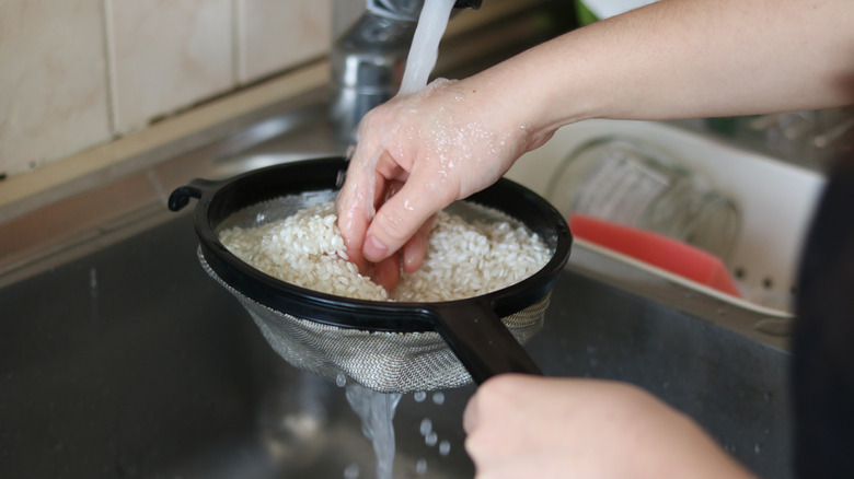 A person rinsing rice