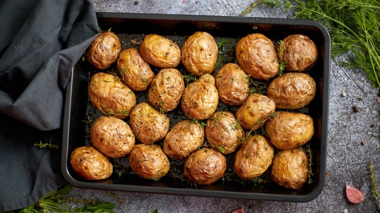 whole baked potatoes on tray