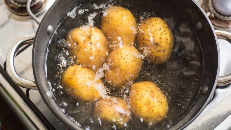 potatoes boiling in saucepan